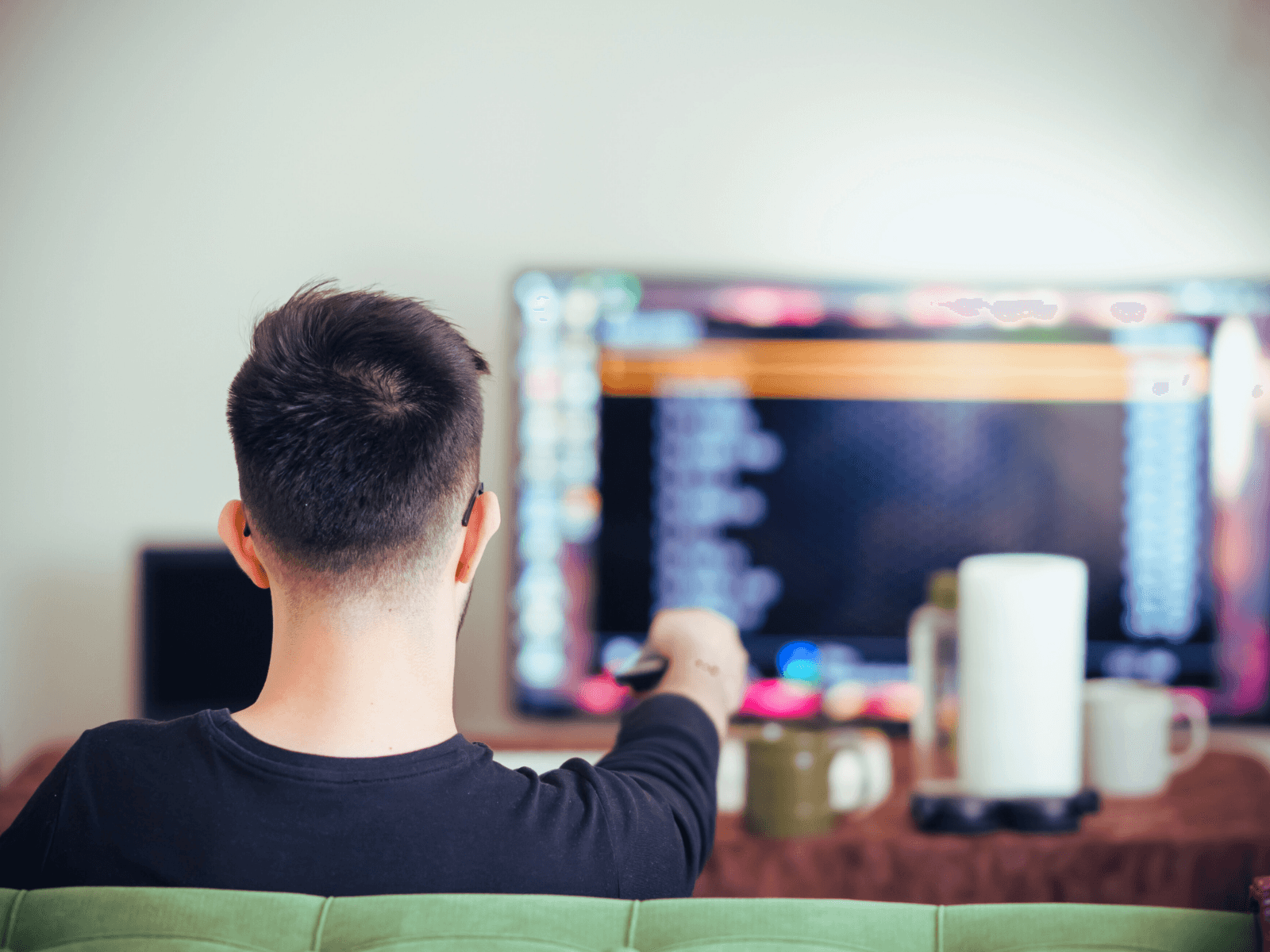 person sitting on couch and watching television